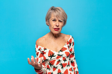 middle age woman looking angry, annoyed and frustrated screaming wtf or what’s wrong with you