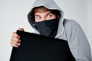 a man in a gray hoodie disguise theft technique hacker