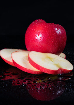 Sliced Red Apple with wateer srpay and refleciton