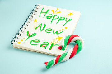 front view happy new year note with candy on blue background color photo holiday new year christmas