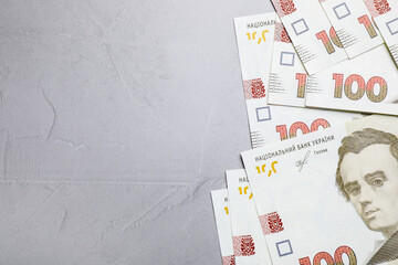 Ukrainian money on grey background, flat lay. Space for text