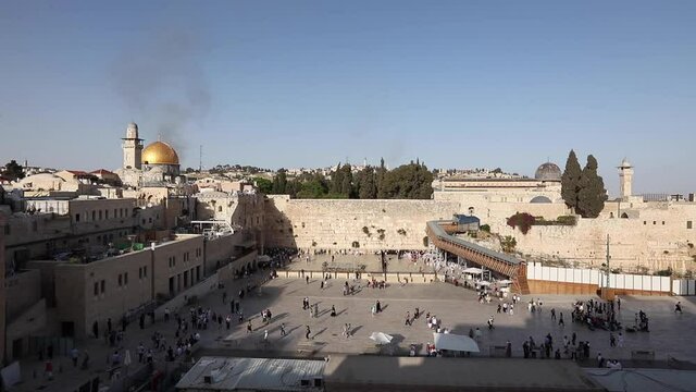People on a beautiful evening pray near the Western Wall in Jerusalem. Israel. Dome of the Rock.