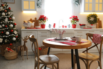 Beautiful kitchen interior with Christmas tree and festive decor