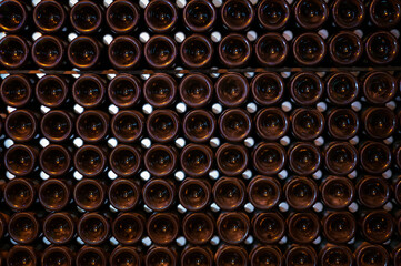 Champagne grand cru sparkling wine production in bottles in rows in underground cellars, Reims, Champagne, France