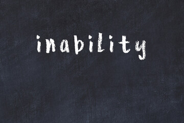 College chalk desk with the word inability written on in