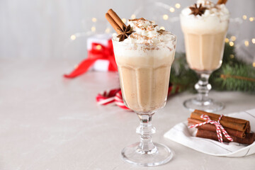 Delicious Christmas cocktail with liqueur on white table. Space for text