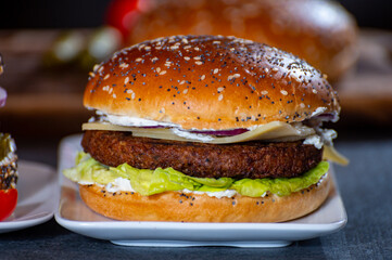 Lunch or dinner with tasty vegetarian hamburgers made from plant based grilled burgers, fresh bakes buns and organic vegetables