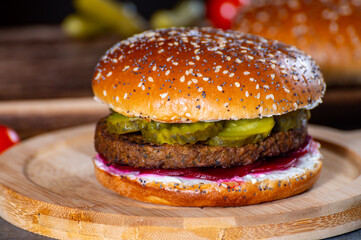Lunch or dinner with tasty vegetarian hamburgers made from plant based grilled burgers, fresh bakes buns and organic vegetables