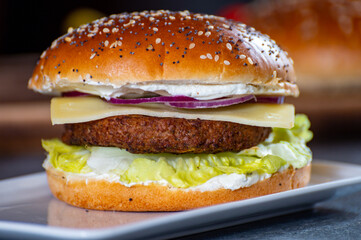 Lunch or dinner with tasty vegetarian hamburgers made from plant based grilled burgers, fresh bakes buns and organic vegetables