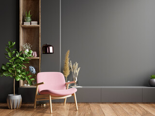 Colorful interior with a pink armchair on empty dark wall background. - obrazy, fototapety, plakaty