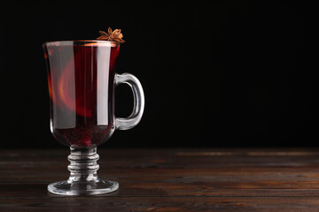 Aromatic mulled wine on wooden table. Space for text