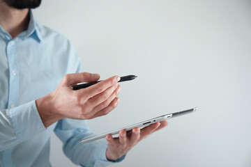 man holding digital tablet and pen