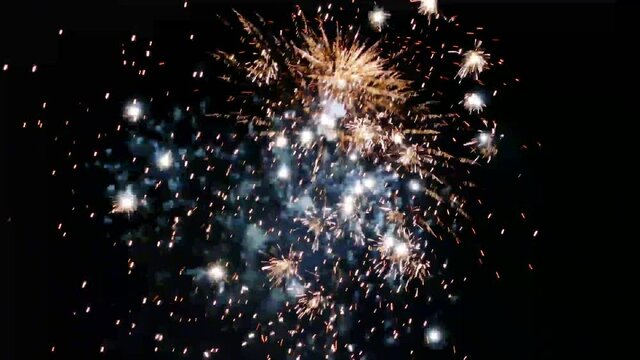 New Year fireworks of white glitter rain in front of a dark night sky with original sound