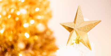 The gold cluster metallic star ornament hanging decorated on the Christmas tree and for the Celebrate with the Christmas season.