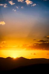 Sun Rays shining at Sunset Sunrise over Mountains