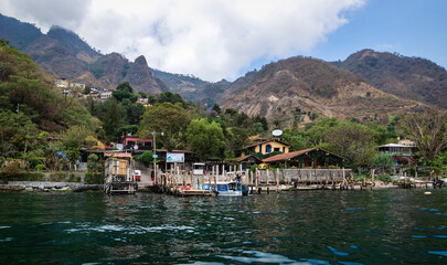 Fototapeta na wymiar View from lake Atitlan to the coast of the mountain village Santa Cruz la Laguna, Guatemala