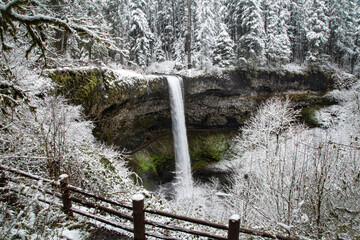 A wide angle view of South Falls at Silver Falls State Park after a snow storm - Silverton, Oregon