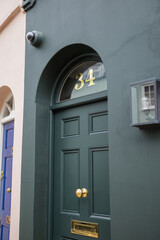 Entrance of dark color building with the number 34