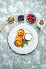 top view delicious muffins with berries on light background taste sugar photo sweet pancake fruit