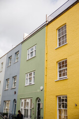 Fototapeta na wymiar Row of colorful British houses with handrails and plants