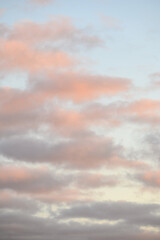 Peaceful pastel light in an evening sky, blue sky and fluffy clouds as a nature background
