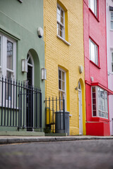 Row of colorful British houses with handrails and plants