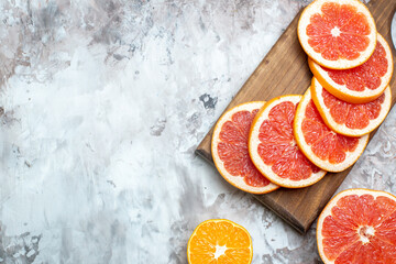 top view fresh grapefruits sliced fruits on light-background citrus fresh color photo fruit free place - Powered by Adobe