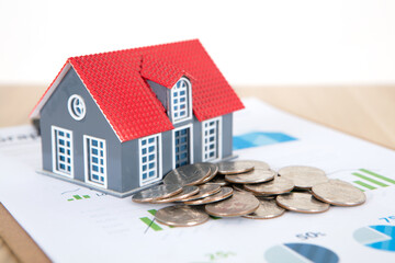 Small house model and dollar coins