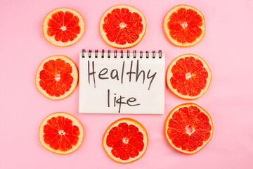 top view tasty grapefruits sliced juicy fruits with healthy life writing on pink background juice fresh fruit color diet