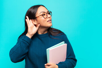 young latin woman looking serious and curious, listening, trying to hear a secret conversation or...