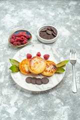 front view delicious muffins with honey and choco biscuits on light background photo sweet pancake cake