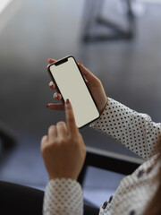 Female hands touching on smartphone screen in blurred background