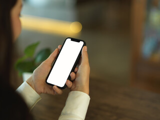 Businesswoman using smartphone in blurred background