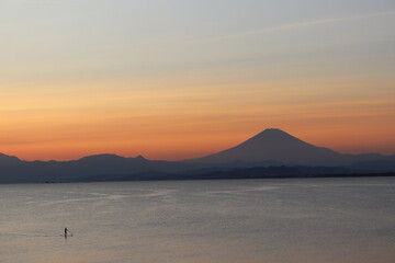 sunset over the sea and SUP man