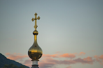 The golden dome of the chapel against the background of the evening sky