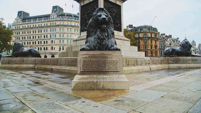 London in Covid-19 Coronavirus lockdown with quiet, empty streets at Trafalgar Square Lions and Nelsons Column in Central London in the City of Westminster, England, UK
