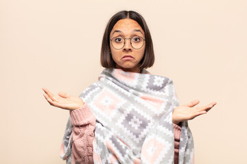 young latin woman feeling puzzled and confused, doubting, weighting or choosing different options...