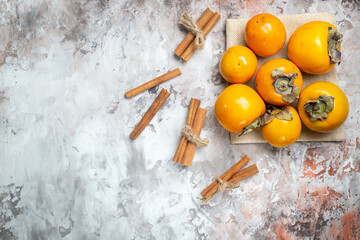 top view fresh persimmons with cinnamon on light background photo fruit tree healthy life ripe color