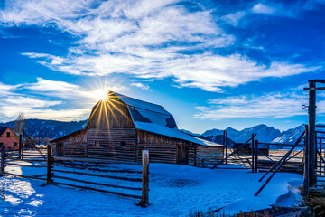 Sun burst over Barn, snow, Clouds, star 