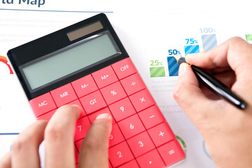 Close-up of hands of financial accountant using calculator