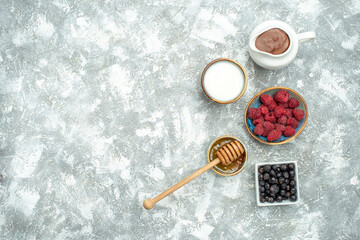 top view fresh raspberries with honey on white background color photo fruit berry free space