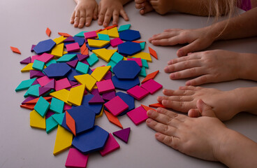 child's hands holding gaming pieces, child development