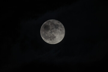 close up of a full moon on pitch black sky