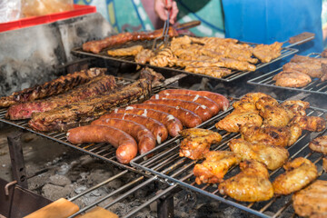 Barbecue Party On The Charcoal Grill - Meat And Kransky On The Grillage