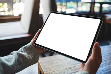Mockup image of a woman holding digital tablet with blank white desktop screen