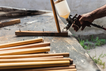 man painting in his wood workshop