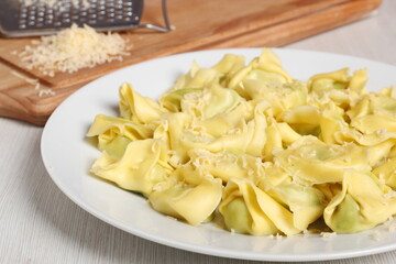 Tortellini stuffed with spinach and ricotta. Covered with grated cheese.
