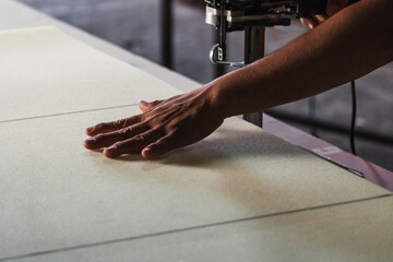 man cutting foam rubber