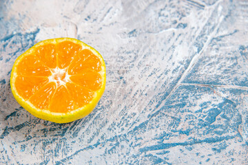 front view fresh tangerine slice on a light-blue background citrus photo fruit juice color