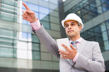 Portrait of manager of plant giving instructions and pointing with his finger